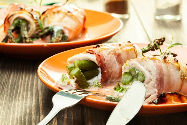 Baked asparagus wrapped in chicken and bacon — Stock Photo, Image