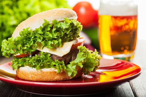 Cheeseburger dans une assiette avec bière — Photo