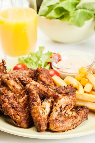 Chicken wings with fries french and spicy sauce — Stock Photo, Image