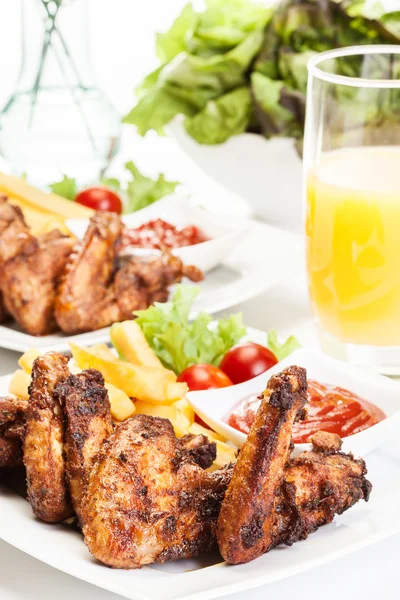 Chicken wings with fries french and spicy sauce — Stock Photo, Image