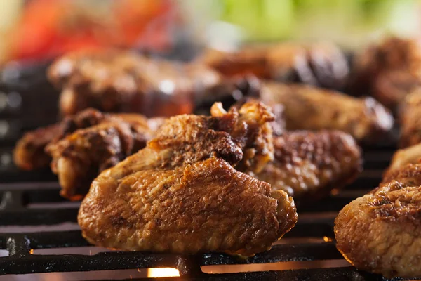 Grilling chicken wings on barbecue grill — Stock Photo, Image