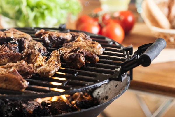 Grilling chicken wings on barbecue grill — Stock Photo, Image
