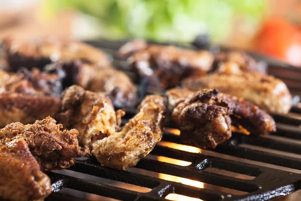 Grilling chicken wings on barbecue grill — Stock Photo, Image