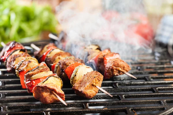 Grilling shashlik on barbecue grill Stock Image