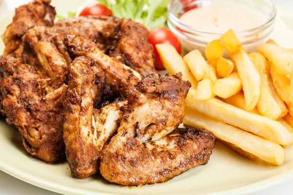 Chicken wings with fries french and spicy sauce — Stock Photo, Image