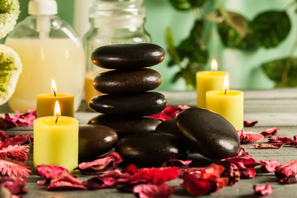 Spa naturaleza muerta con piedras calientes y velas — Foto de Stock