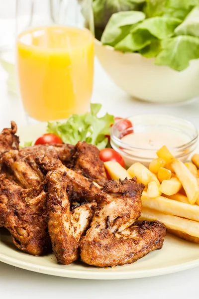 Chicken wings with fries french and spicy sauce — Stock Photo, Image