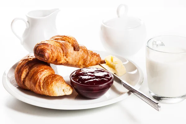 Fresh croissants with butter and a glass of milk — Stock Photo, Image