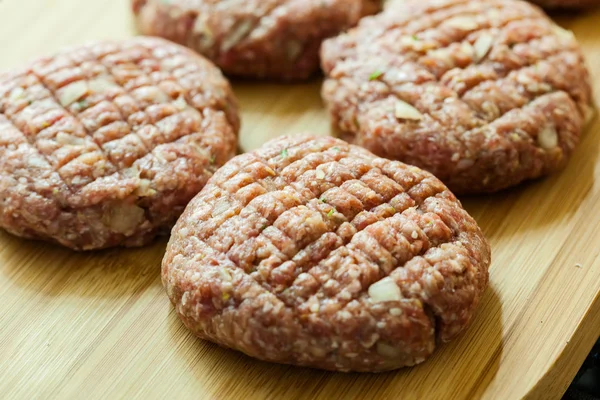 Hamburgers on cutting board — Stock Photo, Image