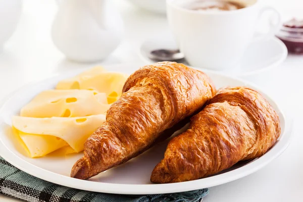 Croissants with cheese, fruits and coffee — Stock Photo, Image