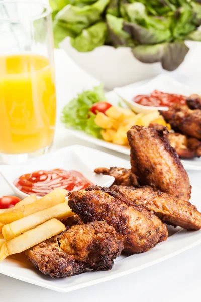 Chicken wings with fries french and spicy sauce — Stock Photo, Image