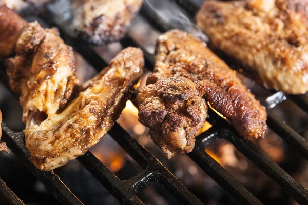 Grilling chicken wings on barbecue grill — Stock Photo, Image