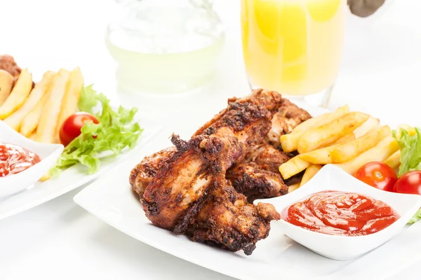 Chicken wings with fries french and spicy sauce — Stock Photo, Image