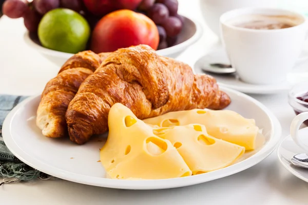 Croissants with cheese, fruits and coffee — Stock Photo, Image