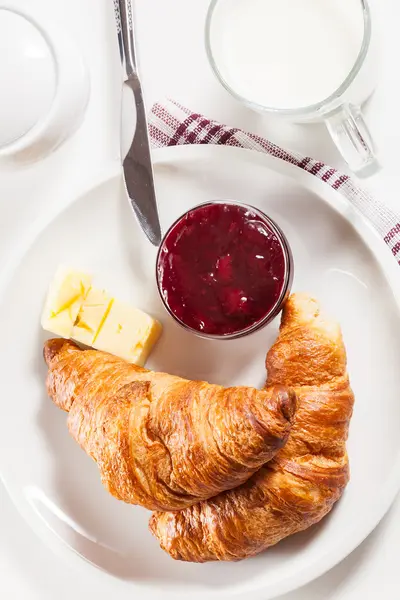 Fresh croissants with butter and a glass of milk — Stock Photo, Image