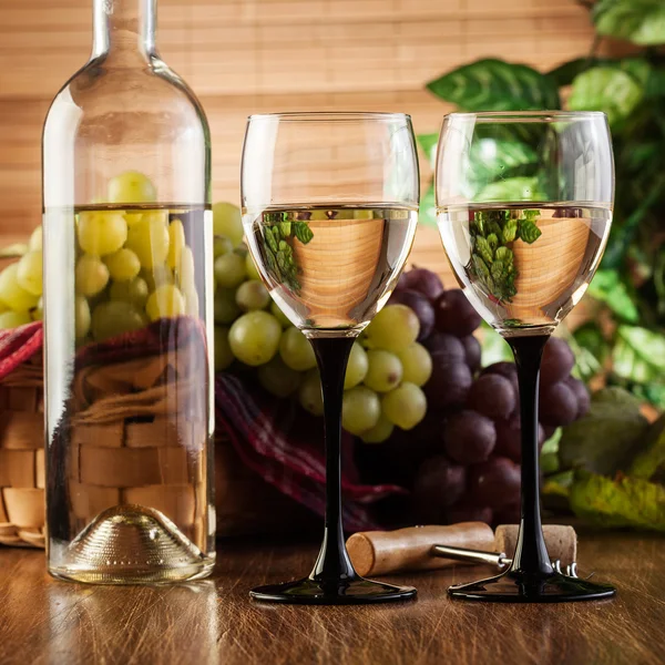 Bottle and glasses of white wine — Stock Photo, Image