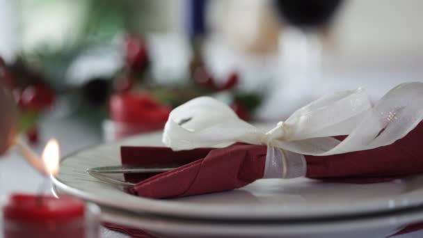 Man lighting a candle on christmas table. Focus on plate — Stock Video