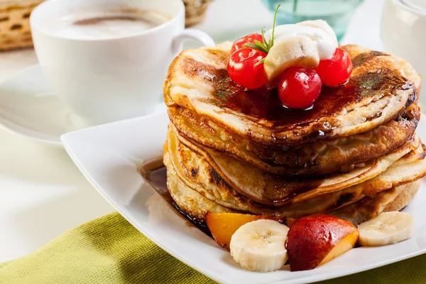 Pancakes with chocolate sauce fruit and coffee — Stock Photo, Image