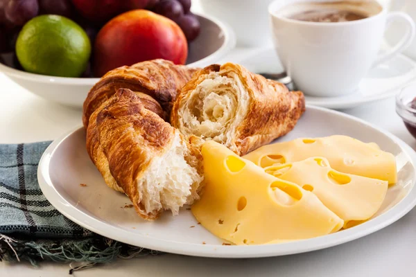 Croissants with cheese, fruits and coffee — Stock Photo, Image