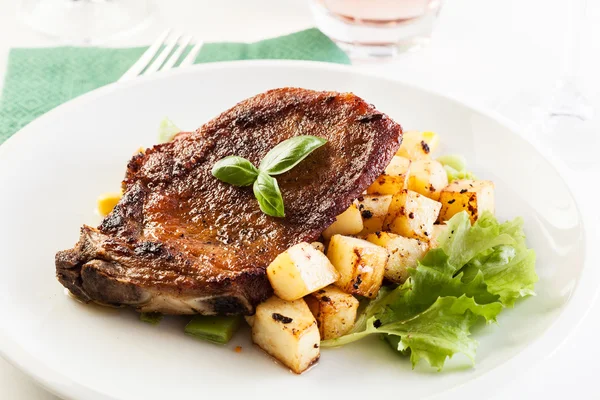 Fried pork with potatoes and vegetables salad — Stock Photo, Image