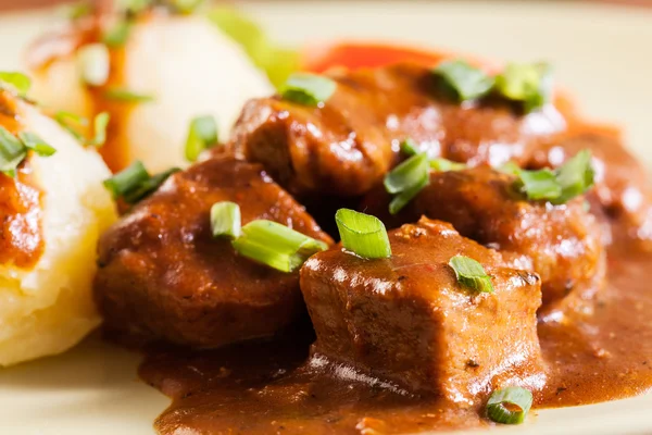 Goulash with boiled potatoes — Stock Photo, Image