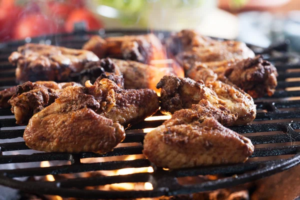 Grilling chicken wings on barbecue grill — Stock Photo, Image