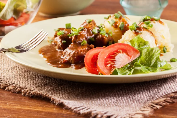 Goulash with boiled potatoes — Stock Photo, Image