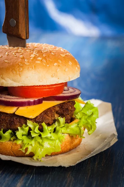 Hamburger pinned with knife — Stock Photo, Image