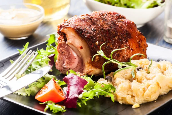 Pork knuckle with fried sauerkraut — Stock Photo, Image