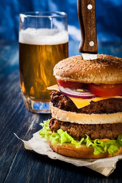 Hamburger pinned with knife — Stock Photo, Image