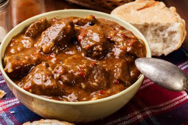 Beef stew served with crusty bread clipart