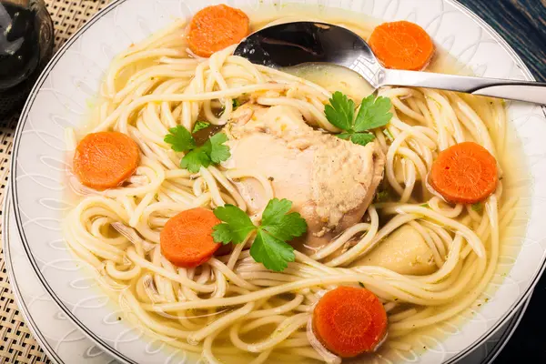 Chicken broth with noodles and carrot — Stock Photo, Image