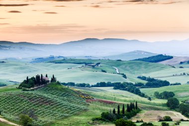 The fairytale landscape of Tuscany fields at sunrise clipart