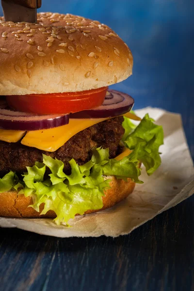 Hamburger pinned with knife — Stock Photo, Image