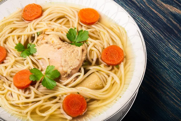 Chicken broth with noodles and carrot — Stock Photo, Image