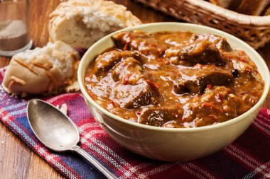 Beef stew served with crusty bread clipart