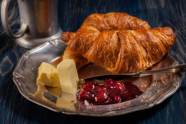 Croissants with butter and a glass of milk — Stock Photo, Image
