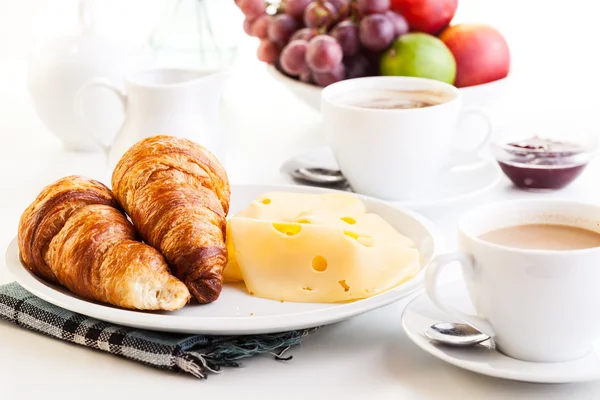 Croissants with cheese, fruits and coffee — Stock Photo, Image
