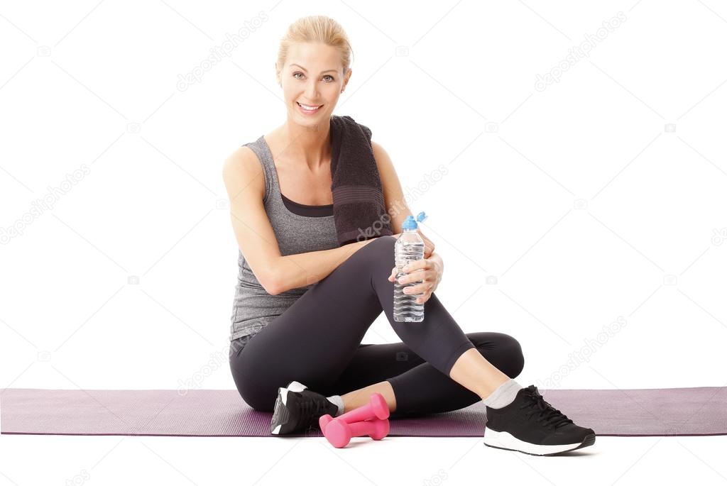 woman sitting on yoga mat