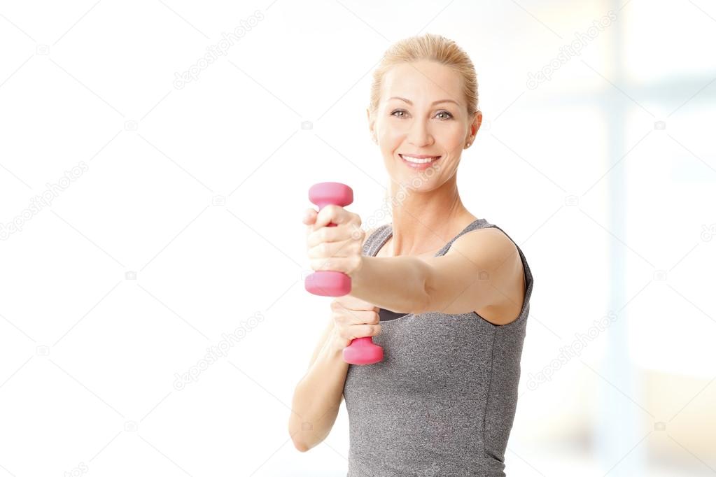 woman working out with dumbbells