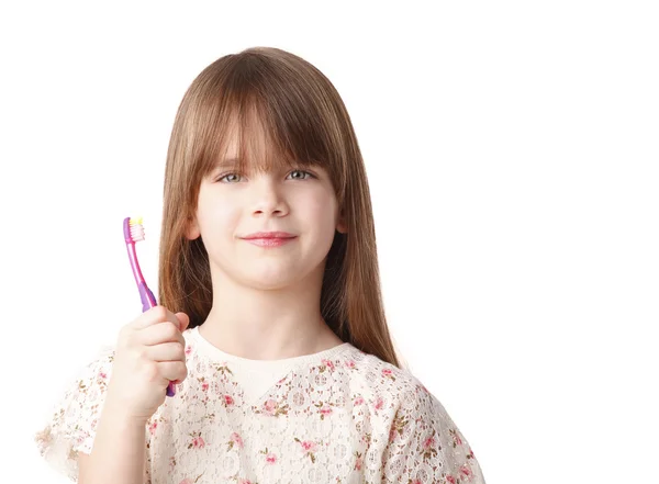 Menina segurando uma escova de dentes — Fotografia de Stock