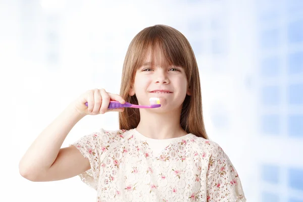 Little girl holding a toothbrush. — Stock Photo, Image