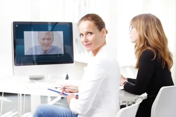 Business women having video conference — стоковое фото