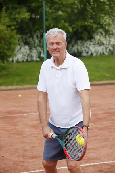 Senior man playing tennis