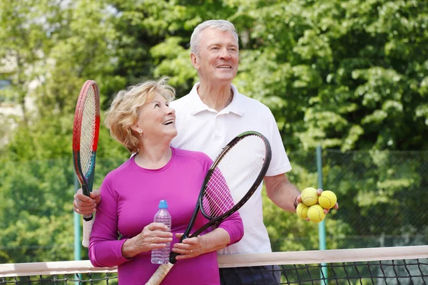 trainer and elderly woman standing