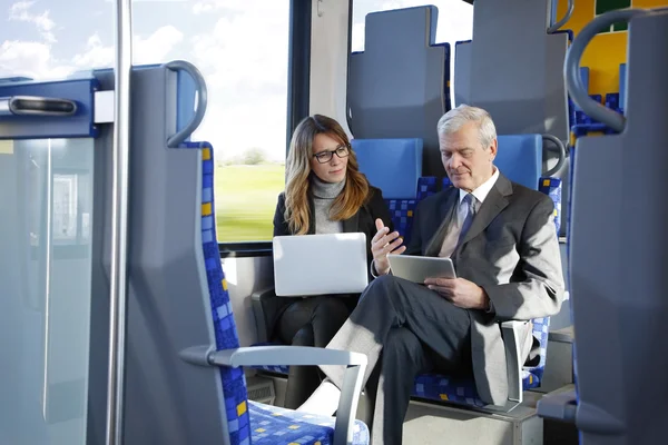 Businesspeople traveling on train — Stock Photo, Image