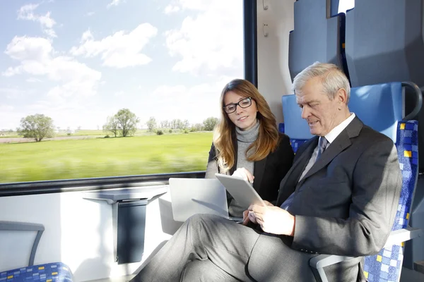 Businesspeople traveling on train — Stock Photo, Image