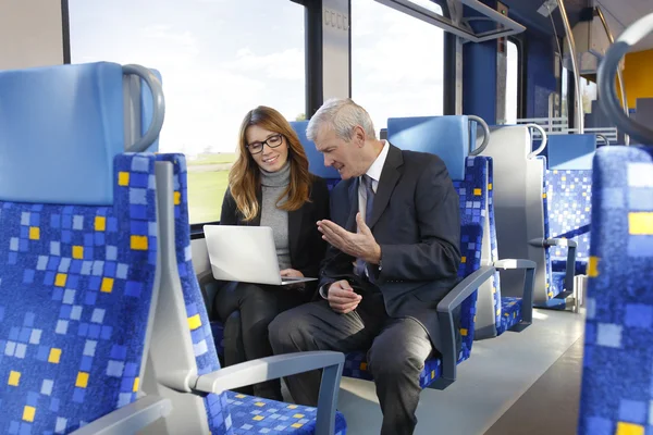 Businesspeople traveling on train — Stock Photo, Image