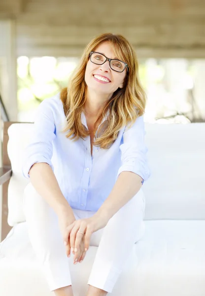 Woman sitting on steps and laughing — Stock Photo, Image