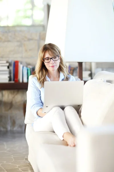 Full Length Portrait Thinking Mature Woman Using Her Laptop While — Stock Photo, Image